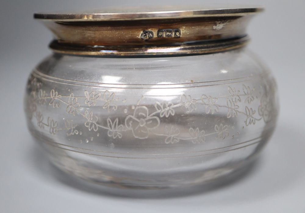 Three various tortoiseshell and silver pique-mounted glass toilet jars and a small silver circular box